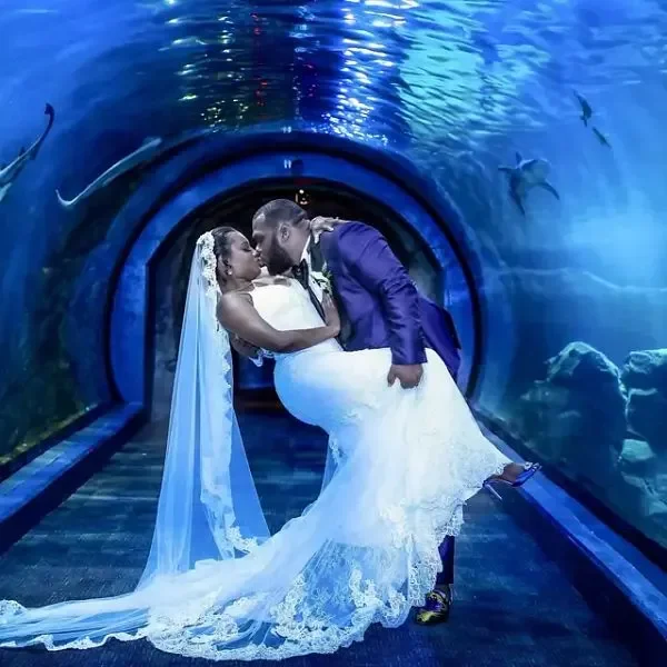 Adventure Aquarium — couple inside the aquarium tunnel