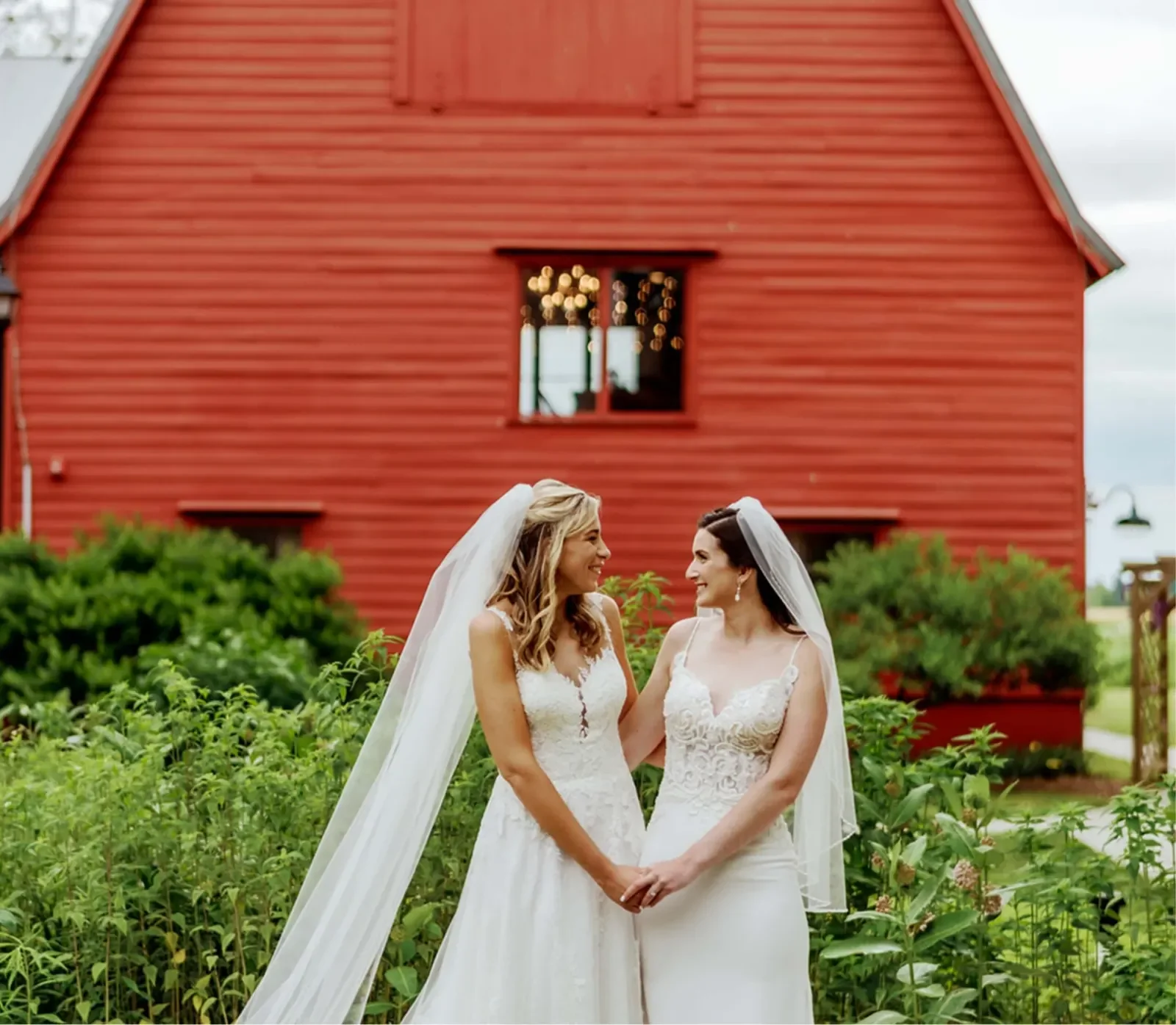 Bishop Farmstead — couple outside the red barn