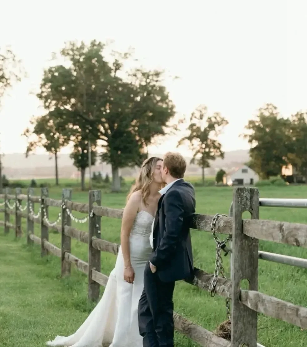 Foxglove Farm — couple beside the farm fence
