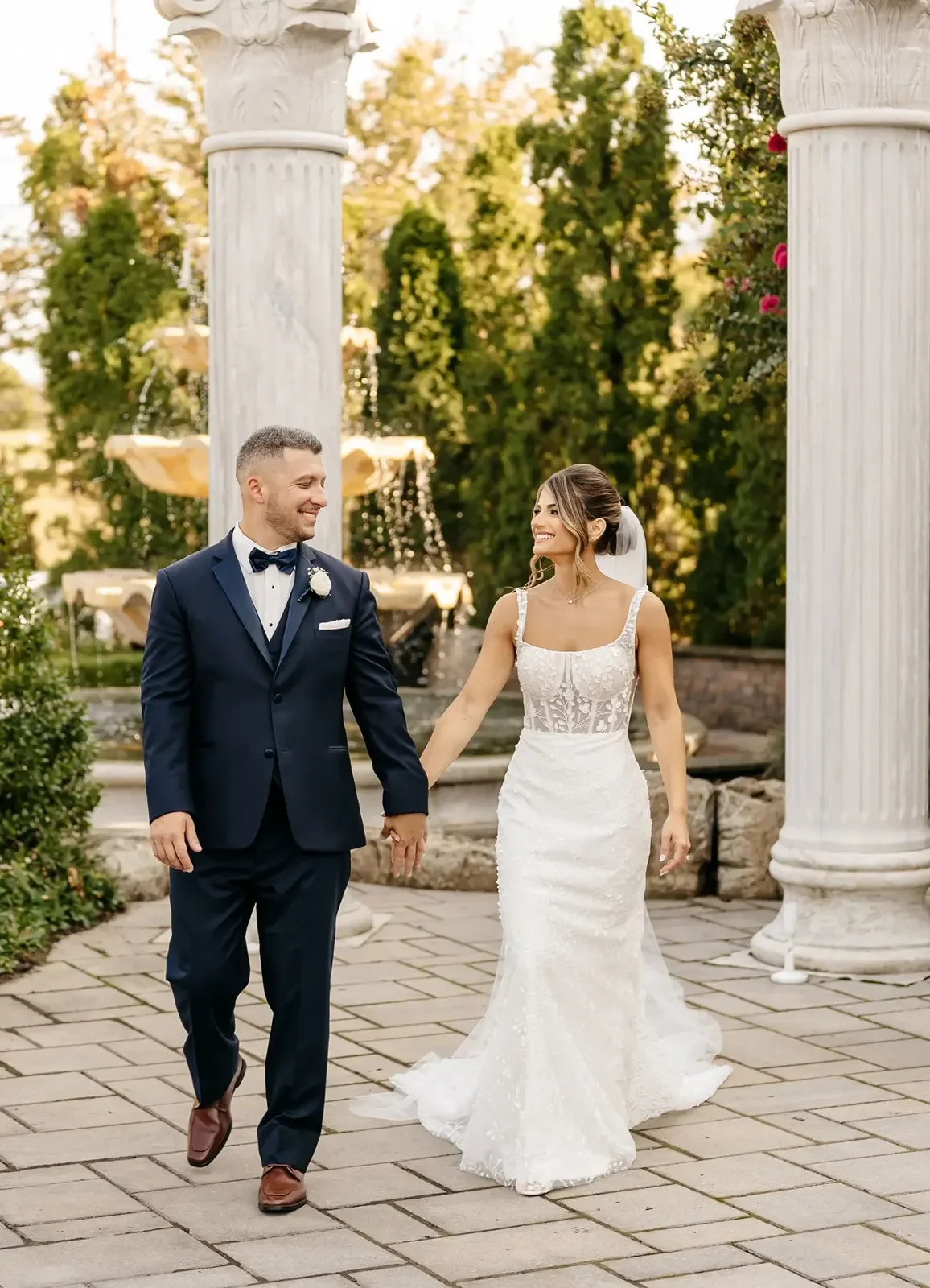 The Merion — couple beside entrance columns